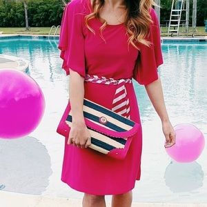 Hot pink dress with cascading sleeves.